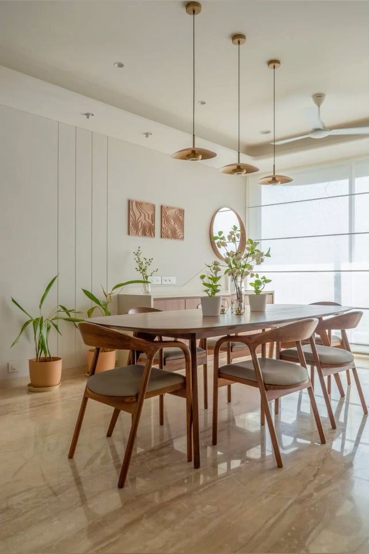 Dining room with arched wall niches, a tiered pendant light and checked dining chairs